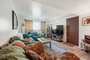 Living area featuring light wood-style floors and baseboards