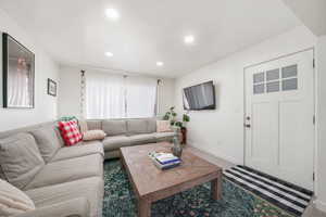 Living area featuring baseboards and recessed lighting