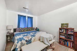 Bedroom with wood finished floors and baseboards