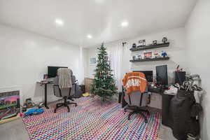 Office space with recessed lighting and wood finished floors