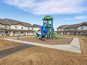 Community playground with a residential view and a yard