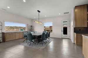 Dining space featuring recessed lighting and light tile patterned floors