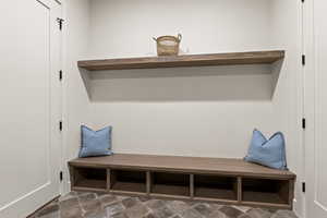 Mudroom with dark stone finish flooring