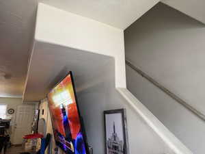 Stairs with a textured ceiling