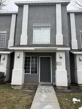 Doorway to property with stucco siding