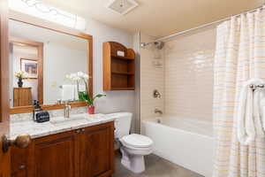 Full bathroom with vanity, shower / tub combo, and light tile patterned floors