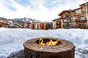 Exterior view of a fire pit and a mountain backdrop