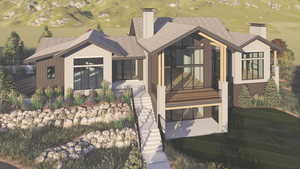 View of front of house with a chimney and golf course view