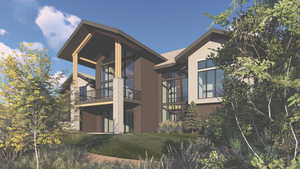 Back of house featuring a balcony and a lawn