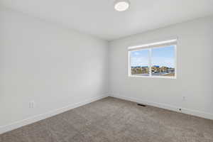 Unfurnished room featuring baseboards and carpet floors