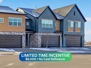 View of front facade featuring stone siding and a garage