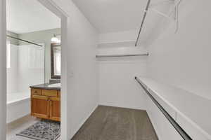 Spacious closet featuring light colored carpet and light tile patterned flooring