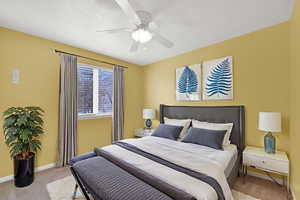 Bedroom with light colored carpet and a ceiling fan