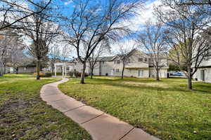 View of home's community featuring a lawn and a residential view