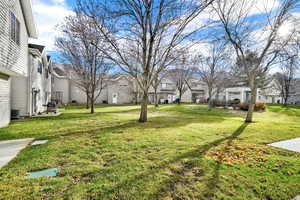 View of green lawn featuring a residential view