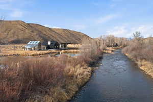 Riverfront property featuring a contemporary residence with skylights and an adjacent pond