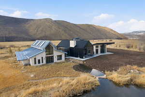 Exterior space featuring a patio, a mountain view, a metal roof, and a view of countryside