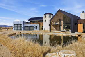 Contemporary residence featuring a distinctive silo-style tower and a prominent A-frame structure