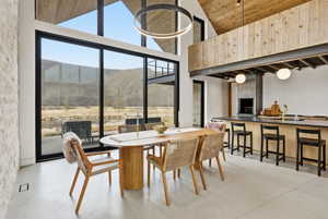 Vaulted wood-paneled ceilings with exposed beams complement the full-height window wall