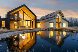 Contemporary twin structures featuring gabled roofs and extensive glass facades
