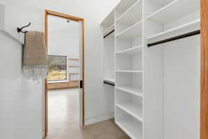 Custom closet system featuring white shelving and dark-finish hanging rods
