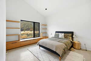 Room featuring a large picture window, vaulted ceiling, built-in lower cabinetry, and open shelving
