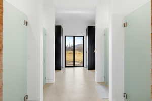 Corridor with vaulted ceiling and baseboards