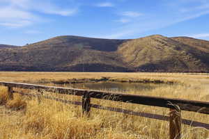 Mountain view featuring a large body of water and rural landscape