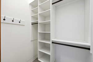 Built-in white shelving system with multiple storage cubbies and hanging rods