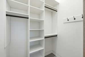 Customizable white shelving system with integrated hanging rods, providing versatile storage solutions