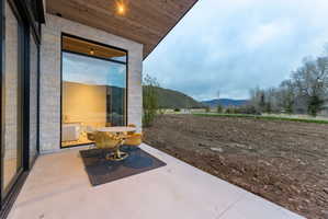 Concrete patio with a wood-finish ceiling and recessed lighting