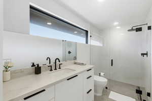 Modern bathroom featuring a double vanity with stone countertops and matte black fixtures
