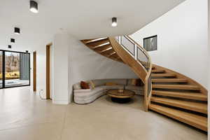 Stairway featuring concrete flooring and baseboards