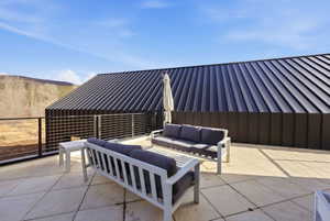 Expansive outdoor terrace featuring large format paver flooring and a modern cable railing