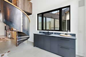 Industrial-style spiral staircase with metal risers and wood-finish handrail