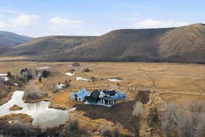 View of mountain background featuring rural landscape and a nearby body of water