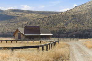 Horse barn featuring a rural view and a mountain view