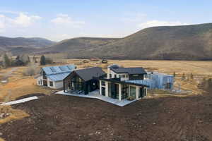 Modern and rustic architectural styles combine in this expansive property featuring multiple structures
