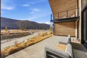 Expansive concrete patio with mountain and water features