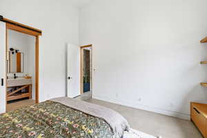 Bedroom with baseboards and a high ceiling
