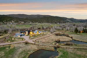 Expansive property featuring a collection of modern architectural structures with illuminated interiors