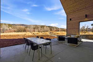 View of patio with outdoor lounge area and a mountain view