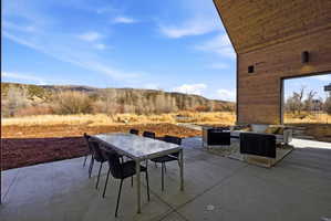 Covered patio featuring a concrete surface and a wood-finish ceiling