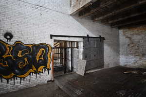 Detailed view of brick wall and a barn door