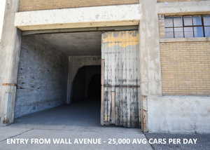Doorway to property featuring brick siding