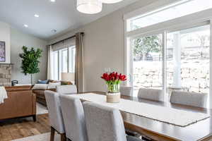 Dining room with hardwood / wood-style flooring and recessed lighting