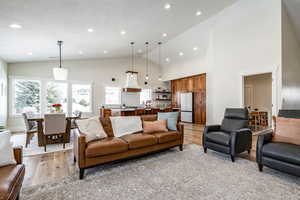 Living room featuring vaulted ceiling, wood finished floors, and recessed lighting