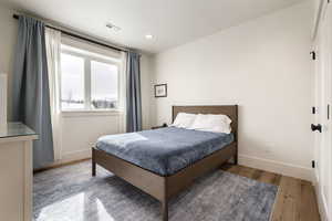 Bedroom featuring hardwood / wood-style floors and recessed lighting