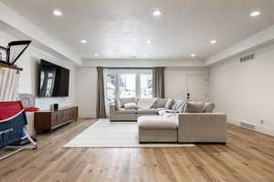 Living room featuring light wood-style floors and recessed lighting