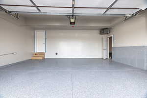 Garage featuring a heating unit and a garage door opener